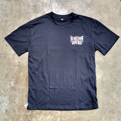 Black t-shirt with a logo on a concrete floor
