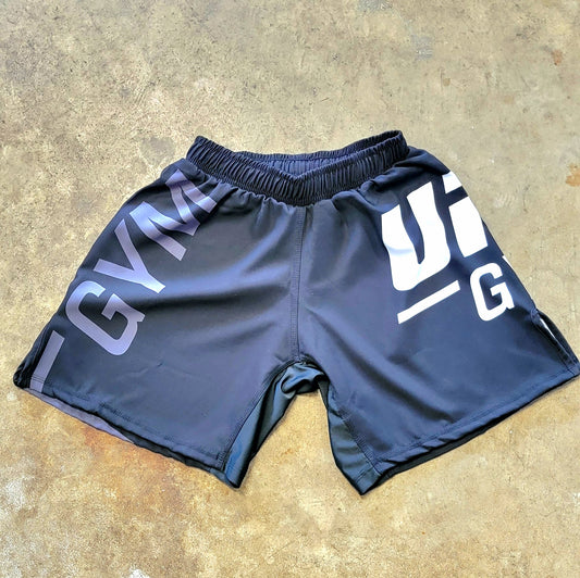 Black shorts with white and gray UFC Gym logos