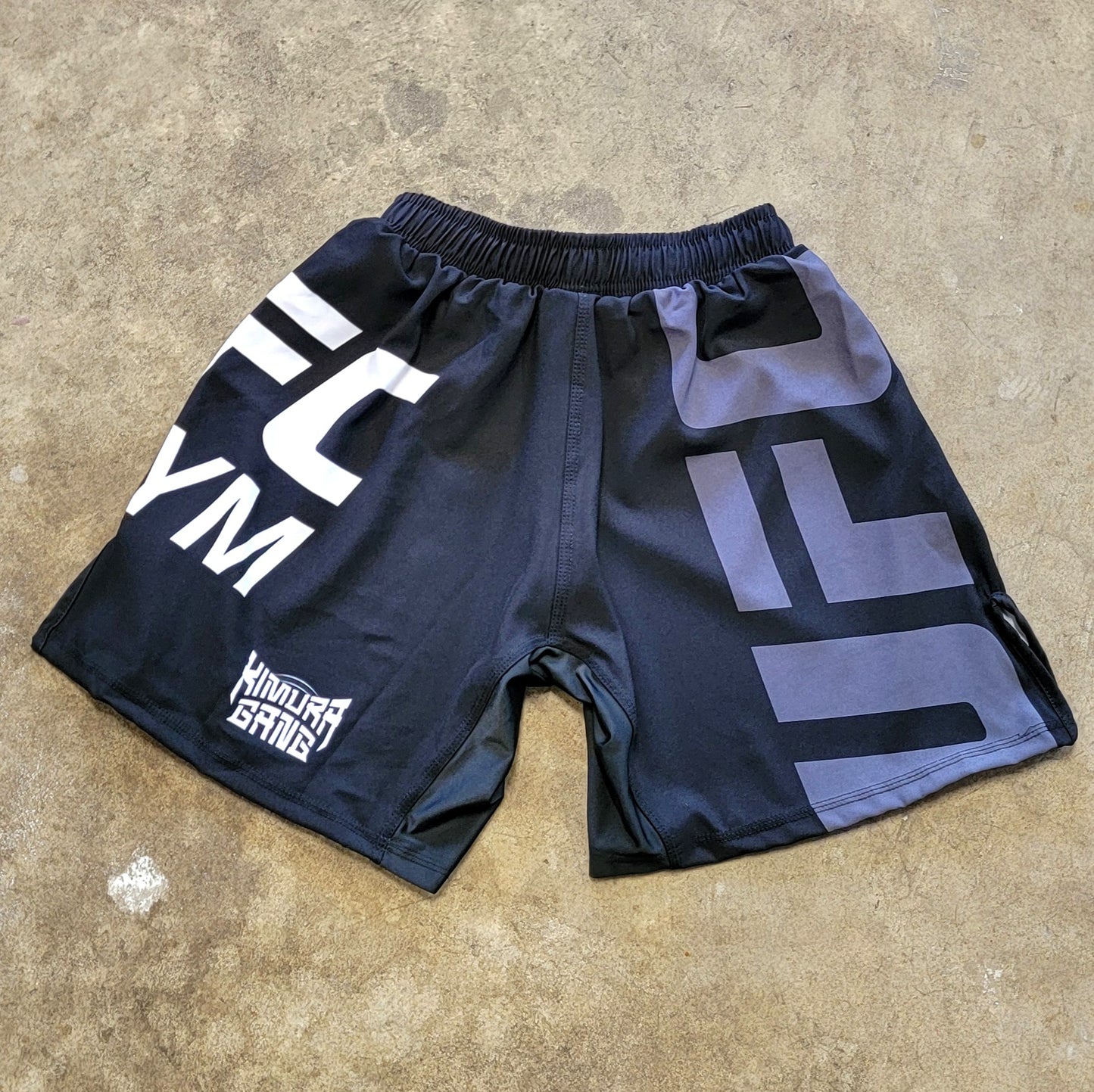 Black shorts with white and gray UFC Gym logos and white Kimura Gang Logo