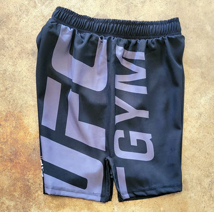 Black shorts with white and gray UFC Gym logos