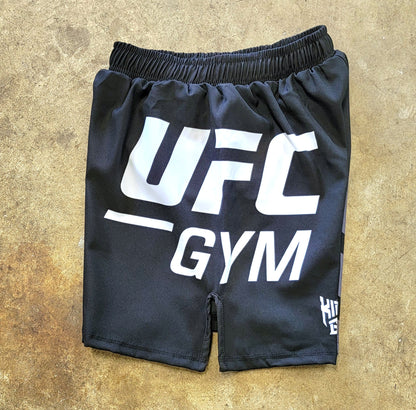Black shorts with white and gray UFC Gym logos