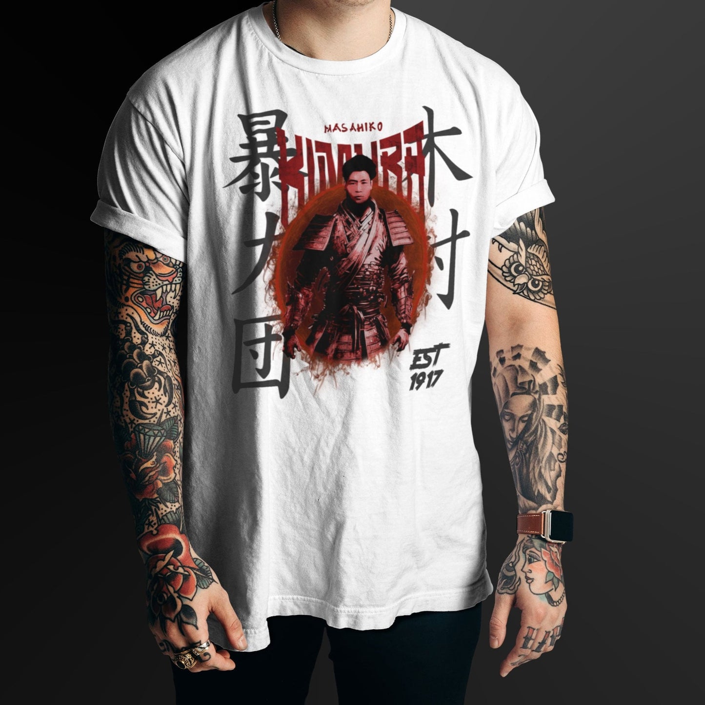 Person wearing a white t-shirt with a graphic design and text, standing against a dark background.